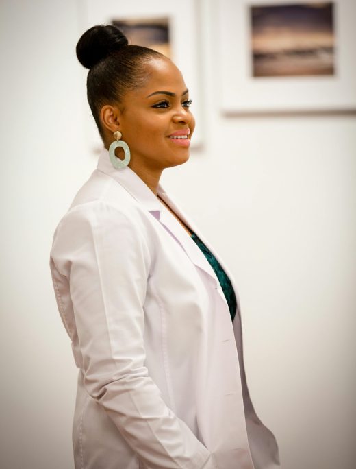 Portrait of a smiling female doctor in a white coat, exuding professionalism and confidence.